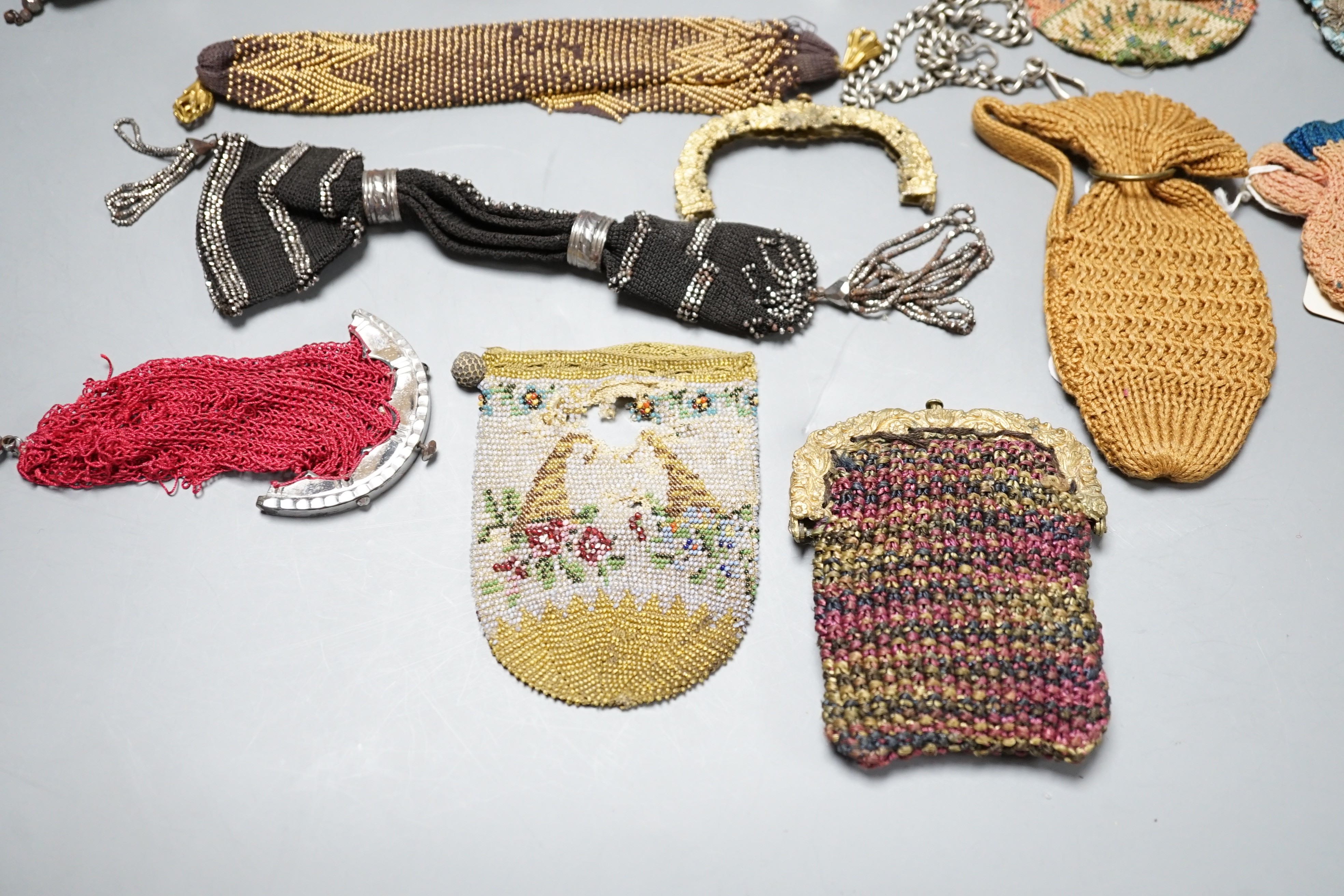 Seven 19th century cut steel misers purses, five beaded and knitted metal framed purses, two reticules, two novelty knitted jug shaped purses and two others